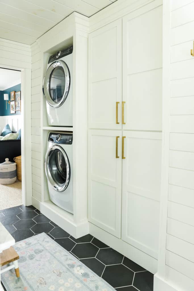a stacked washer and dryer in a small bathroom